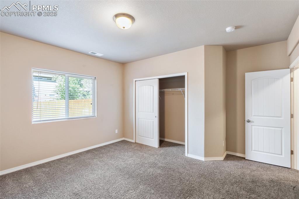 Image 30 of 45: Bedroom Basement Level - Unfurnished bedroom featuring a closet and carpet