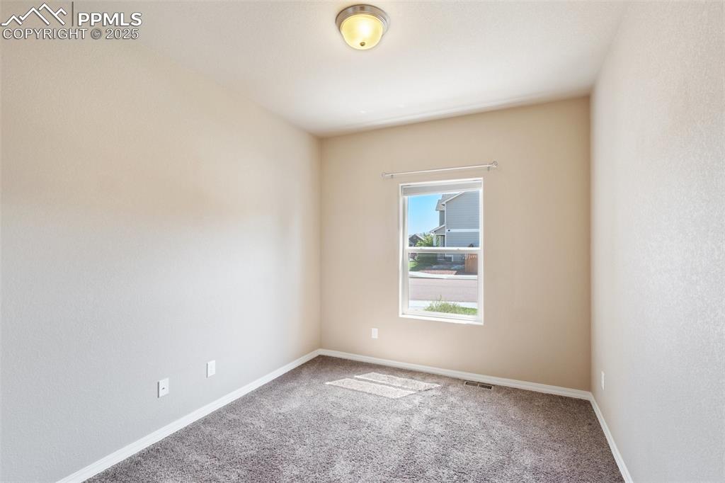 Image 32 of 45: Basement Bedroom - Carpeted empty room featuring baseboards