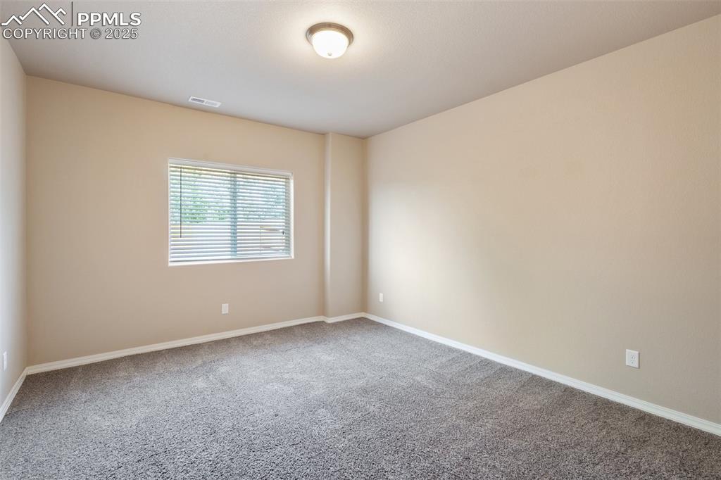 Image 33 of 45: Basement Bedroom - Carpeted spare room with baseboards