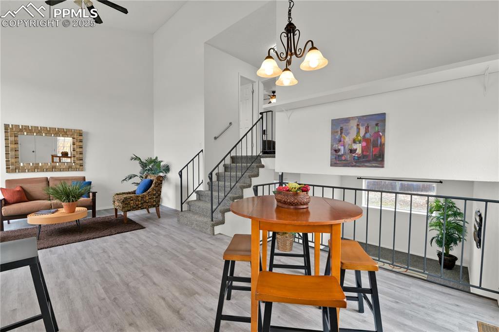 Image 10 of 28: Another view of the main level featuring light wood-type flooring, stairs, 