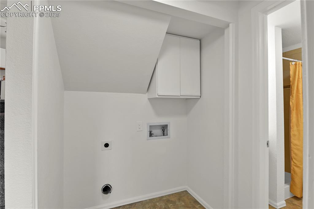 Image 23 of 28: Laundry area on the lower level featuring hookup for a washing machine, ele