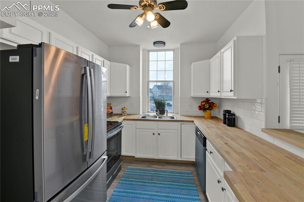 Image 6 of 28: Kitchen featuring brand new appliances with stainless steel finishes, white