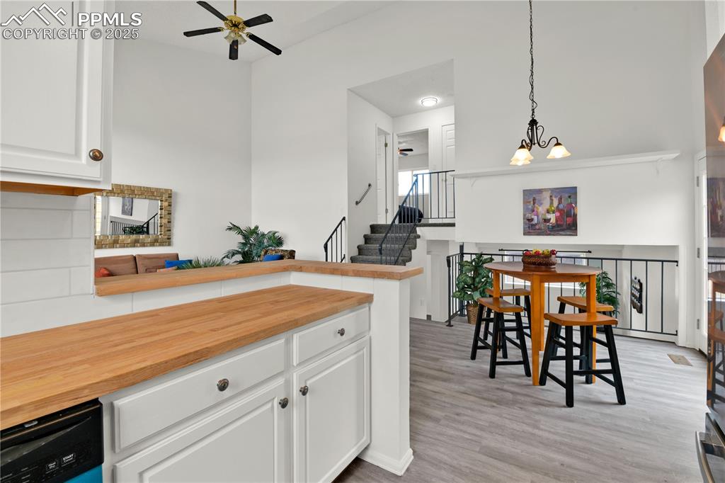 Image 9 of 28: Kitchen featuring pendant lighting, white cabinets, brand new dishwasher, b