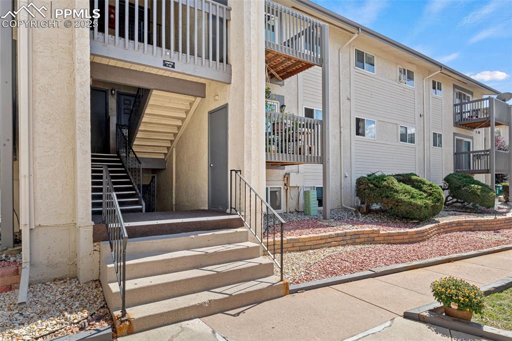 Caption: View of exterior entry with stucco siding