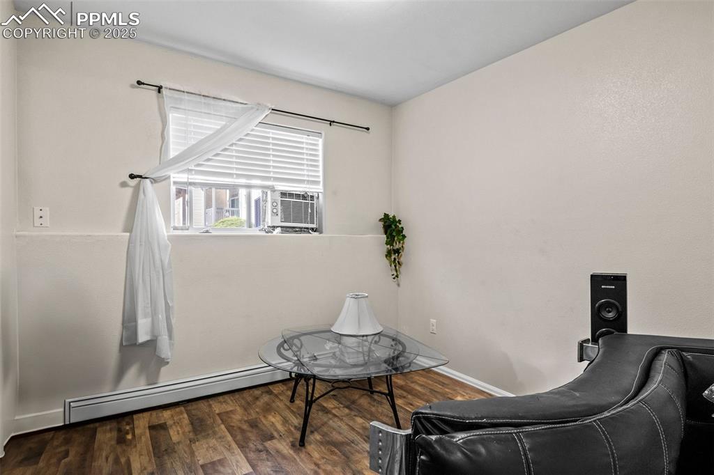 Image 19 of 21: Sitting room featuring a baseboard radiator and wood finished floors