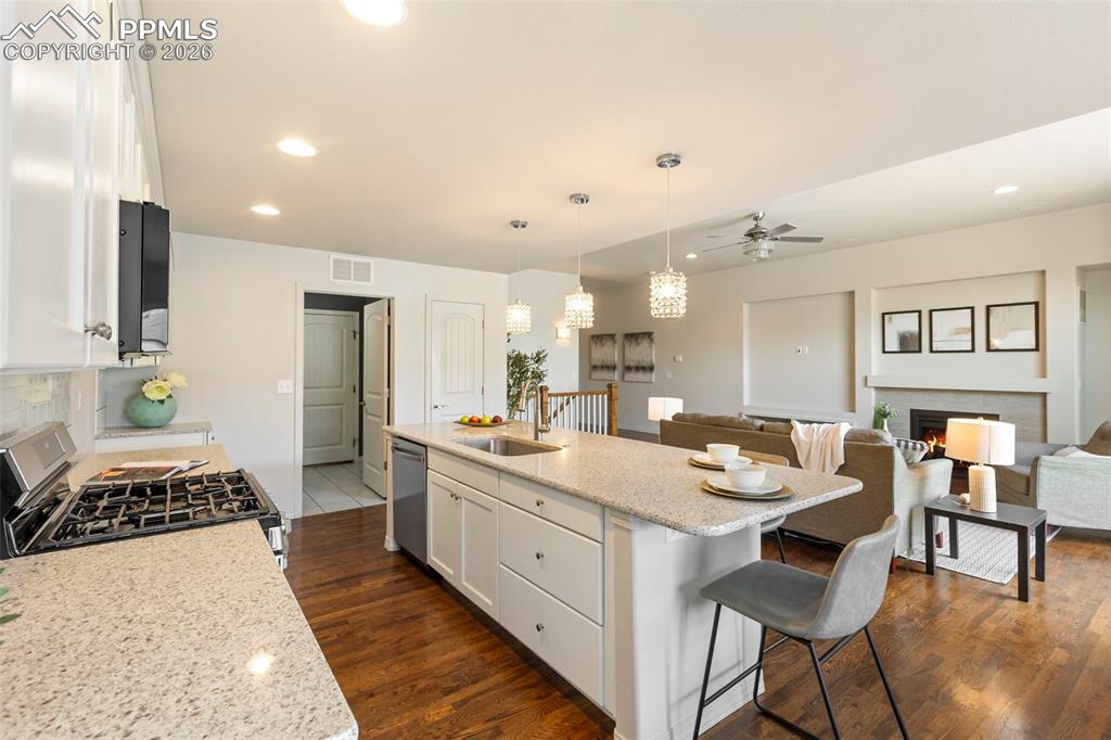 Image 12 of 44: Dining area with modern pendant lighting overlooking the backyard.