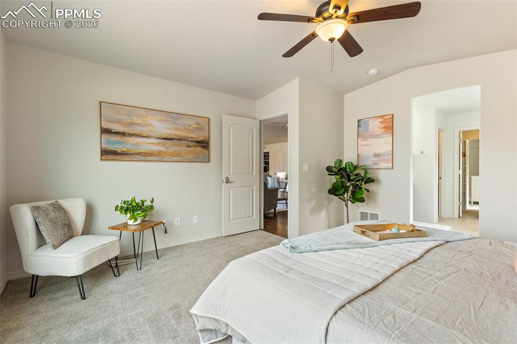 Image 19 of 44: Custom double walk-in closet featuring built-in drawers, shelving, and hang