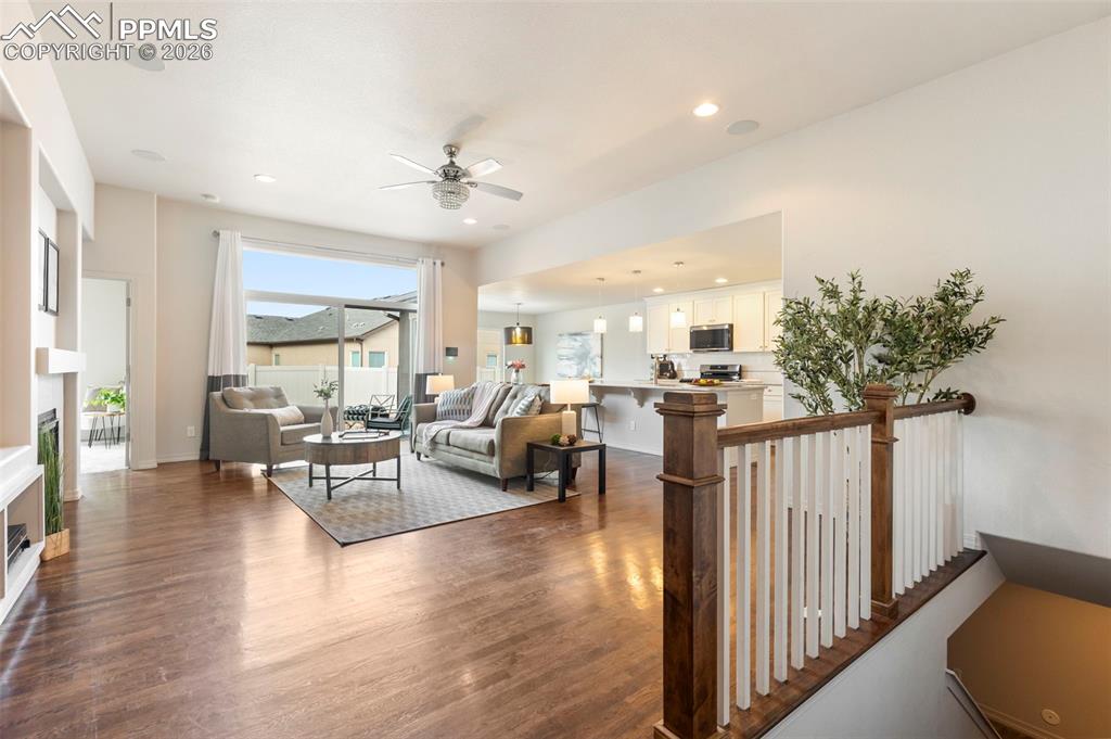 Image 3 of 44: Gas fireplace anchoring the main living space with lots of natural light 