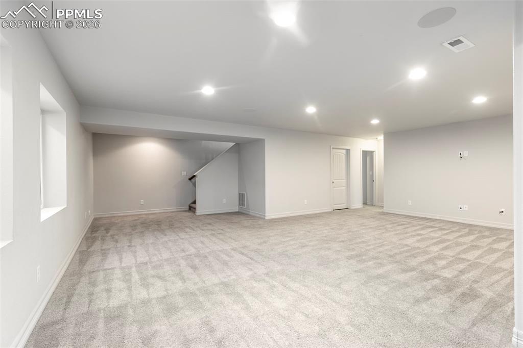 Image 31 of 44: Large lower-level family room offering additional space for entertainment, 
