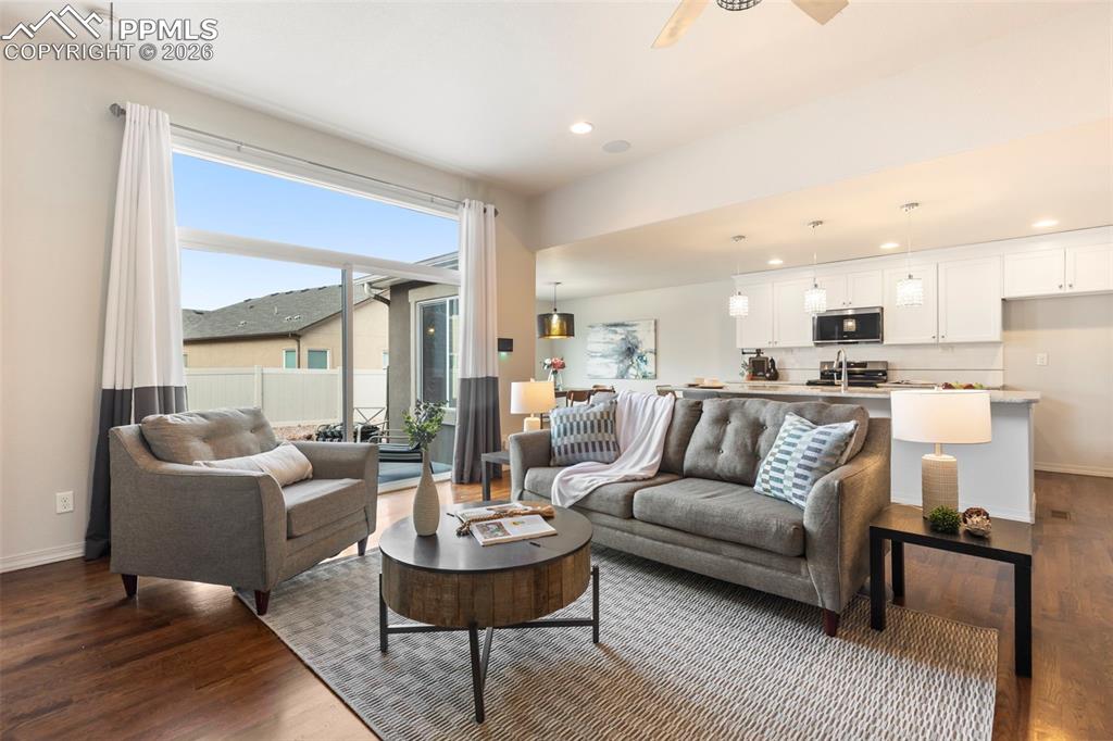 Image 5 of 44: Open-concept main-level living with hardwood floors and seamless flow to th