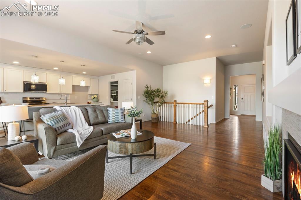 Image 6 of 44: Great room featuring a gas fireplace, surround sound, media center, and ind
