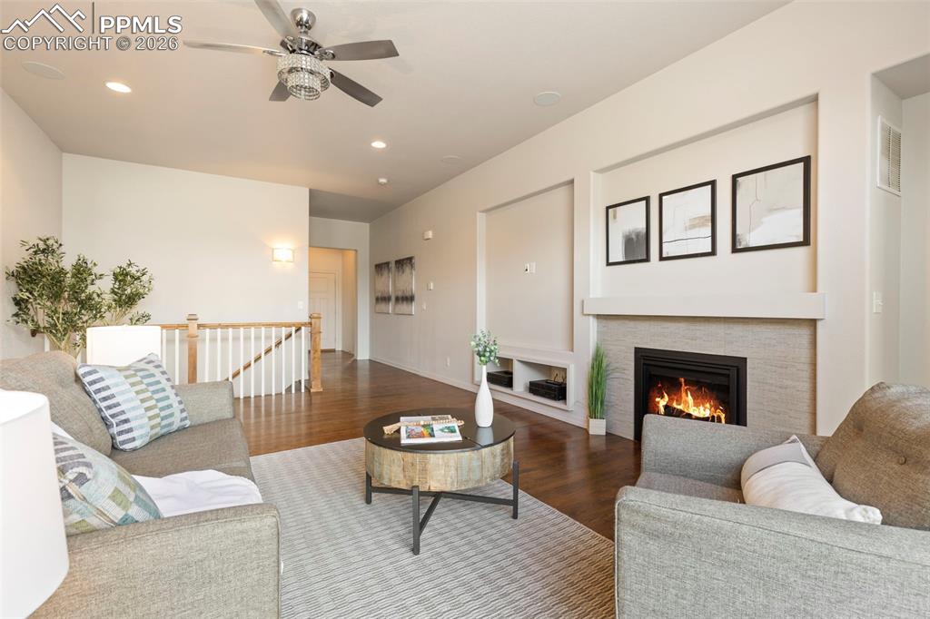 Image 7 of 44: Kitchen with stone countertops, large center island with seating, white cab