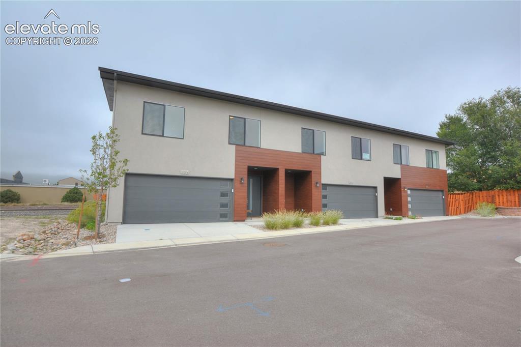 Image 2 of 25: Contemporary multi-family building with a flat roofline