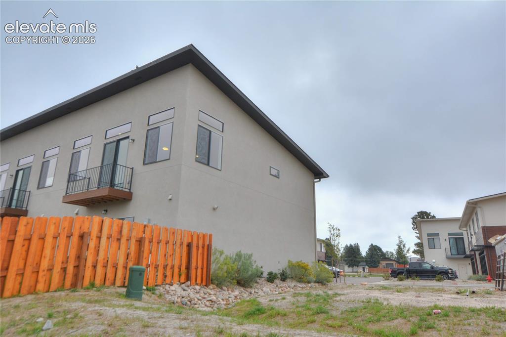 Image 5 of 25: Modern architecture featuring a light-colored exterior, multiple windows, a