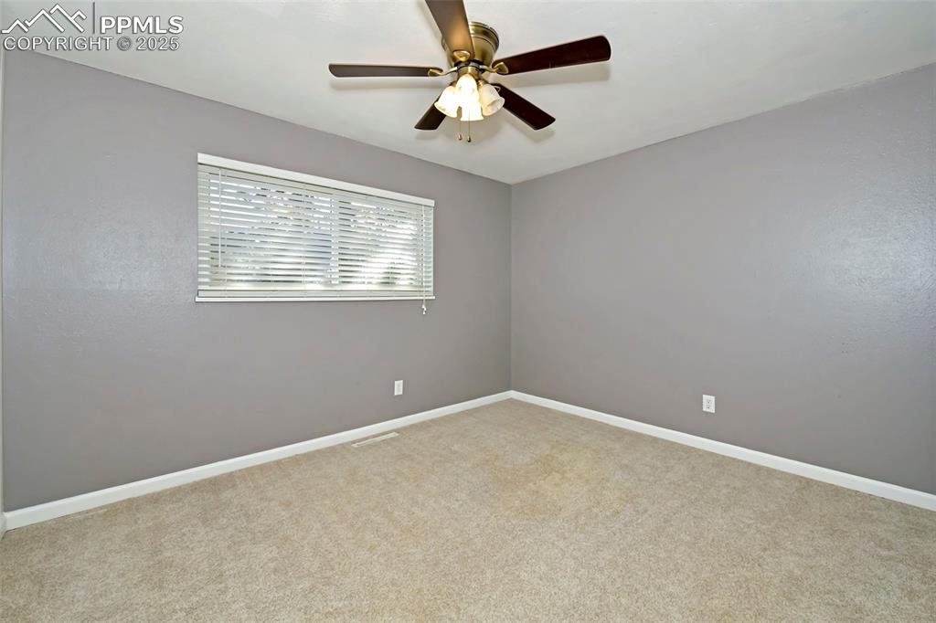 Image 19 of 39: Carpeted empty room featuring ceiling fan and baseboards