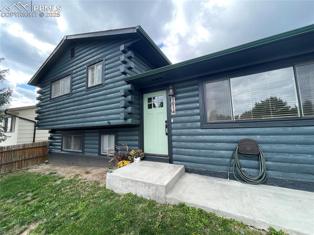 Image 2 of 39: Rear view of house with log exterior