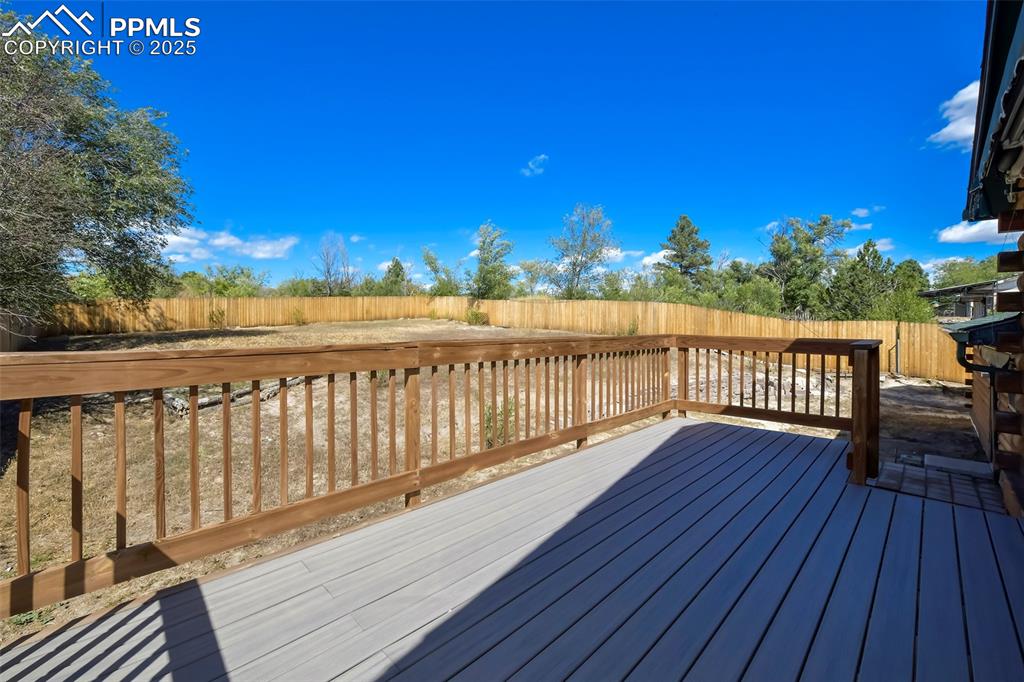 Image 31 of 39: Deck with a fenced backyard