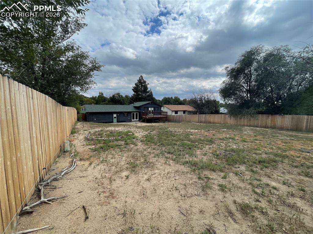 Image 35 of 39: Fenced backyard featuring a wooden deck