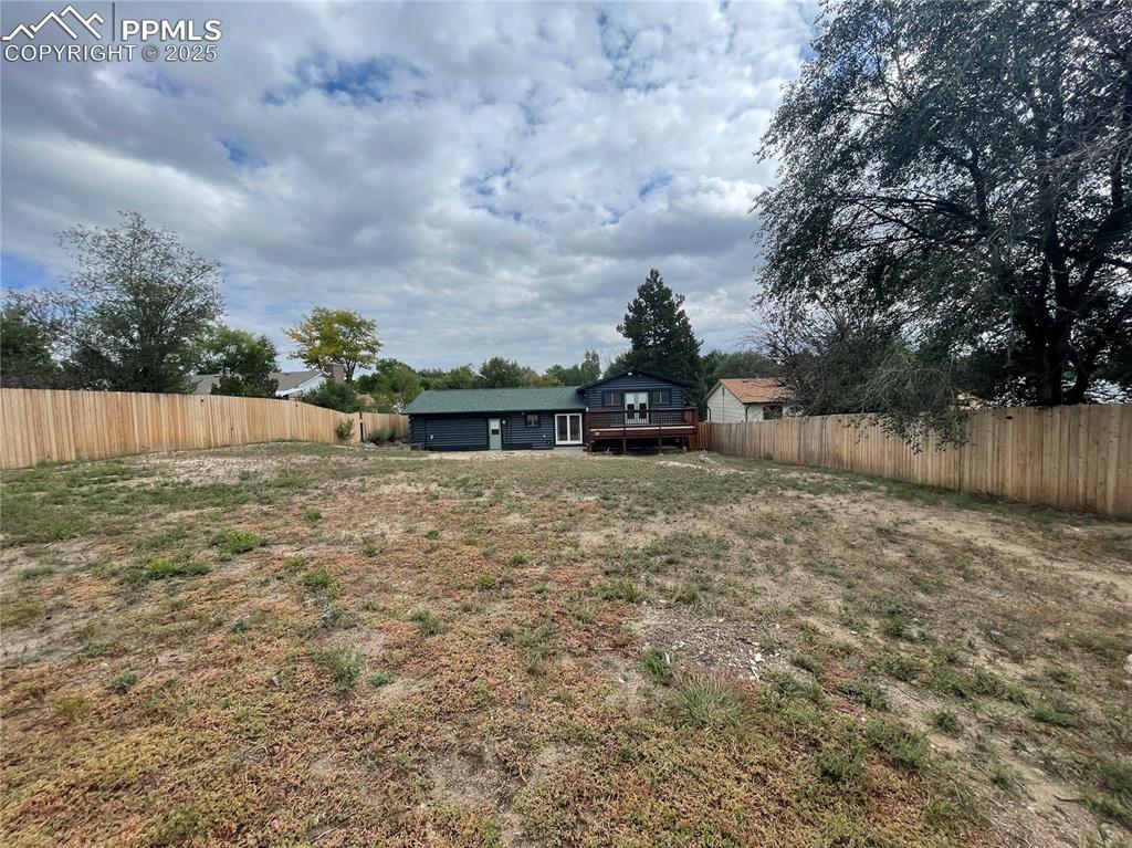 Image 36 of 39: Fenced backyard featuring a deck