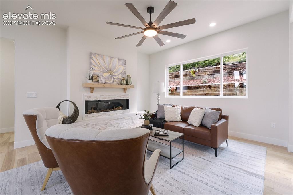 Image 18 of 49: The Great Room offers a lighted ceiling fan and electric fireplace for chil