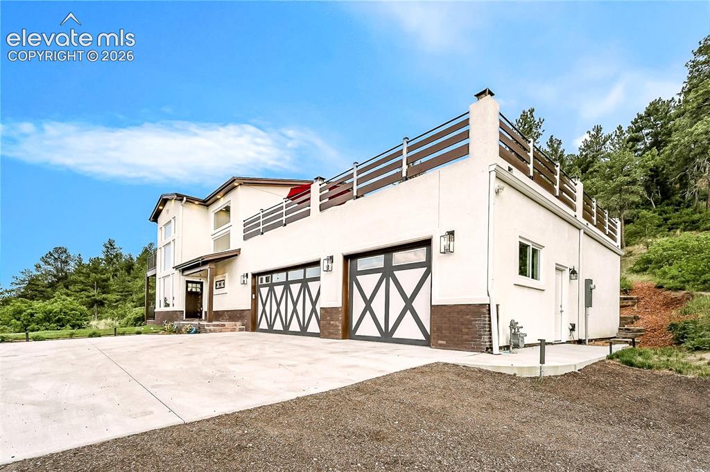Image 2 of 49: Daytime view of the front of the home with 3-car heated garage.