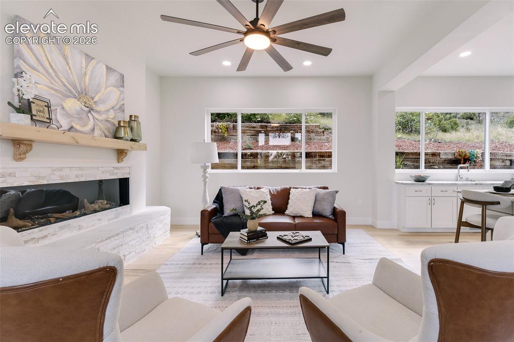 Image 20 of 49: Great Room with walls of windows that bring in lots of natural light.