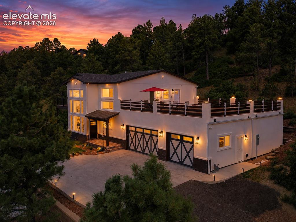 Image 3 of 49: Sunset view of home with expansive composite deck for outdoor dining, relax