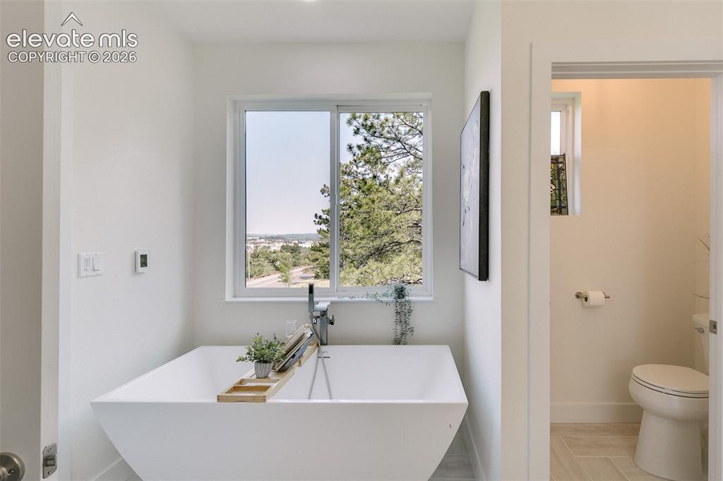 Image 33 of 49: Relax and enjoy beautiful views from the large soaking tub in the Primary B
