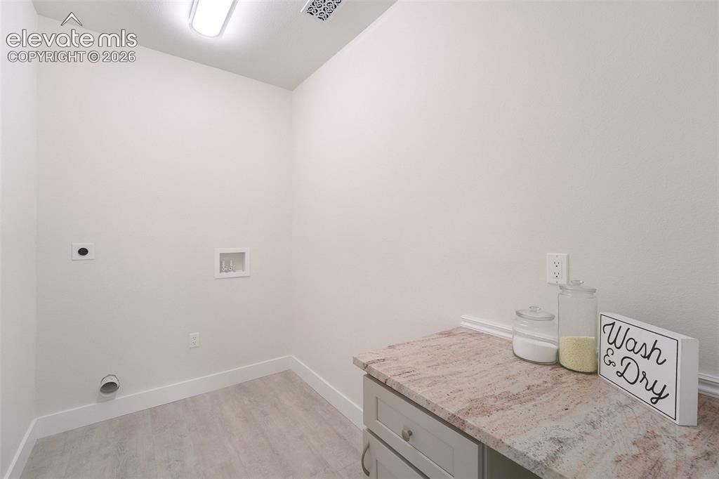 Image 39 of 49: Convenient Upper Level Laundry Room with folding station.