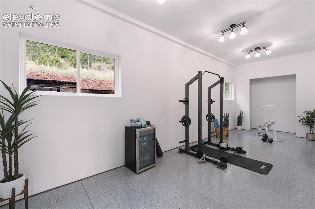 Image 40 of 49: Flex Room off the garage that can be used as a gym, workshop, storage, or m