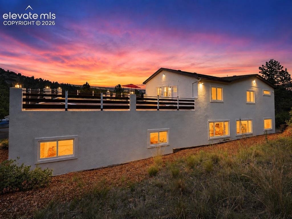 Image 46 of 49: Sunset side view of home and deck.