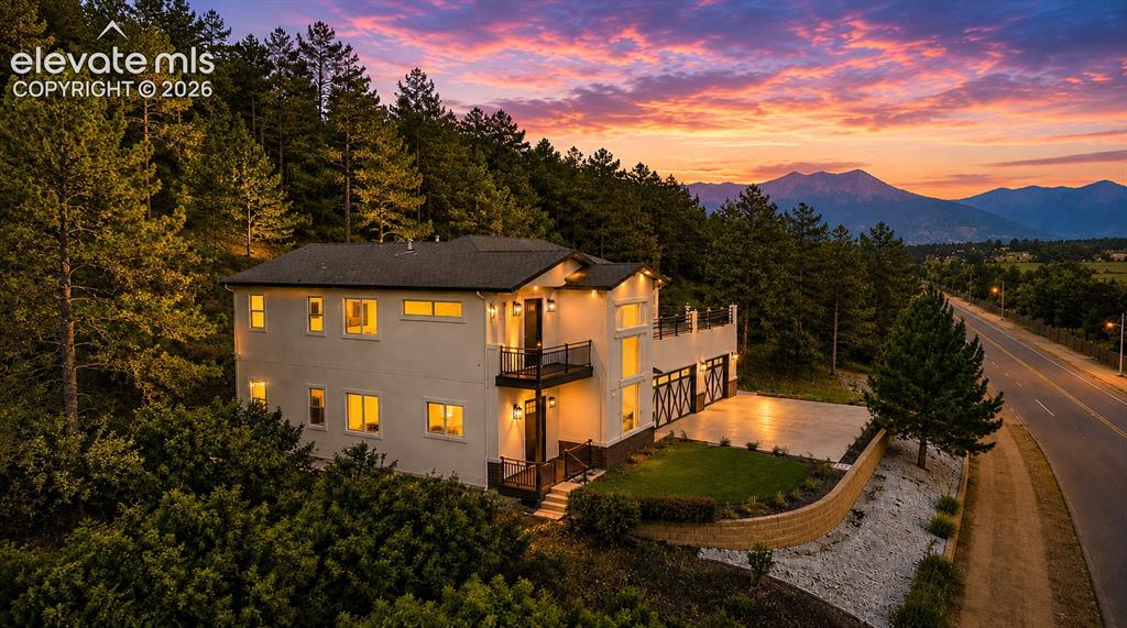 Image 47 of 49: house is perched on a hillside with stunning views