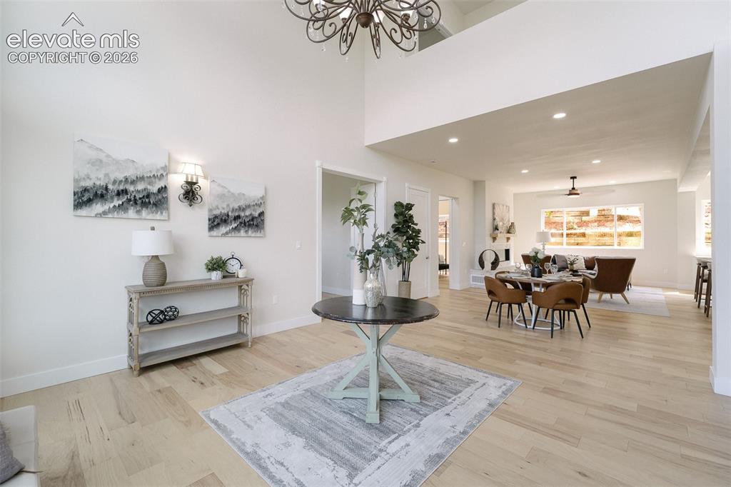 Image 6 of 49: The Living Room has soaring ceilings and flows into the Dining Area and Gre