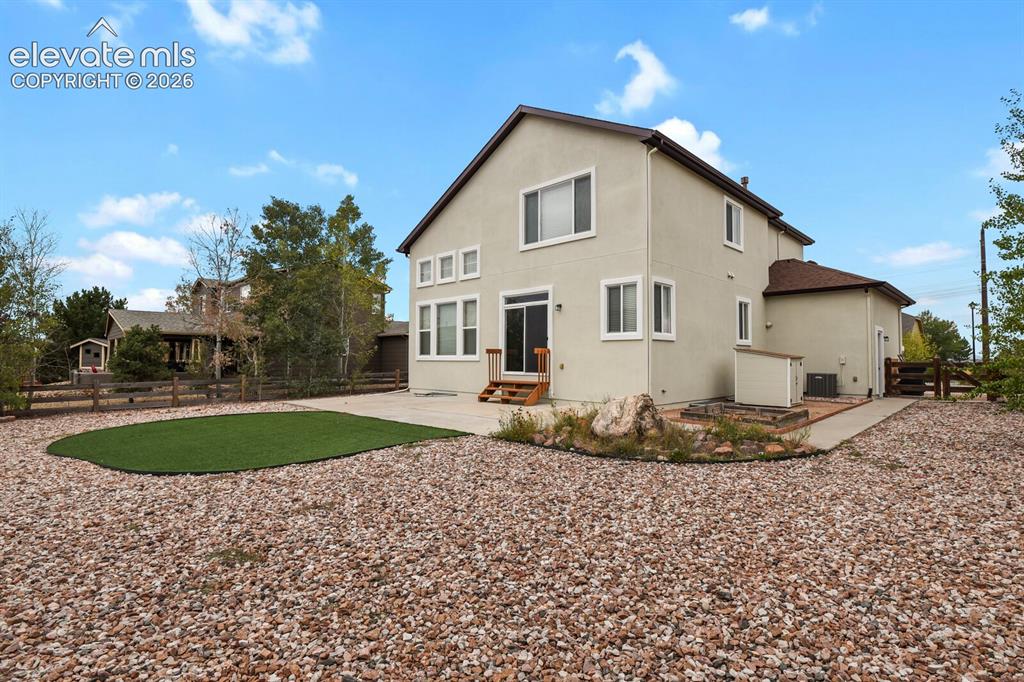 Image 44 of 50: Exterior with stucco finish, multiple windows, sliding glass door, patio ar
