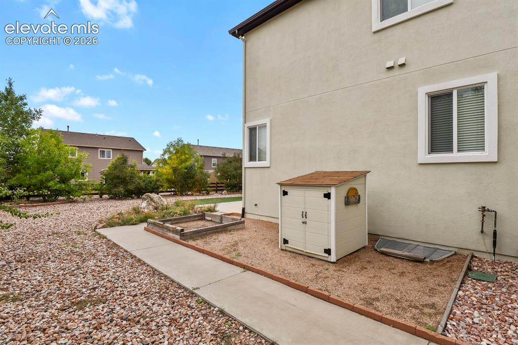 Image 48 of 50: Expansive exterior with stucco siding and multiple windows, featuring a gra