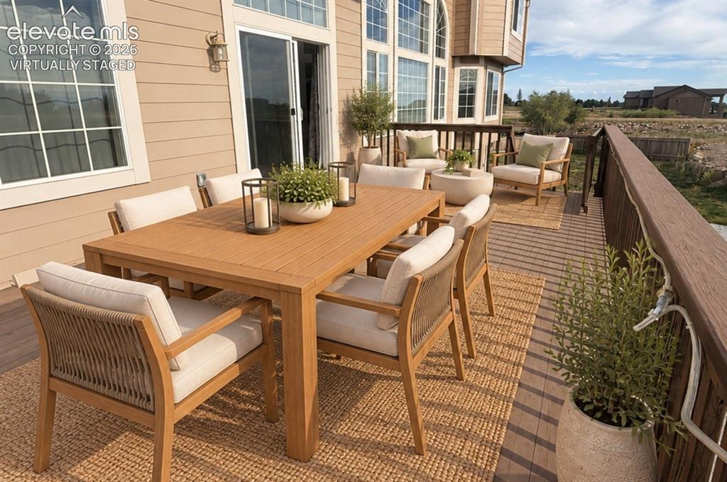Image 15 of 48: Expansive rear deck featuring composite decking and a dark wood-finish rail