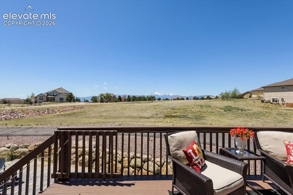Image 18 of 47: Expansive outdoor deck featuring wood-finish flooring and a sturdy wood rai
