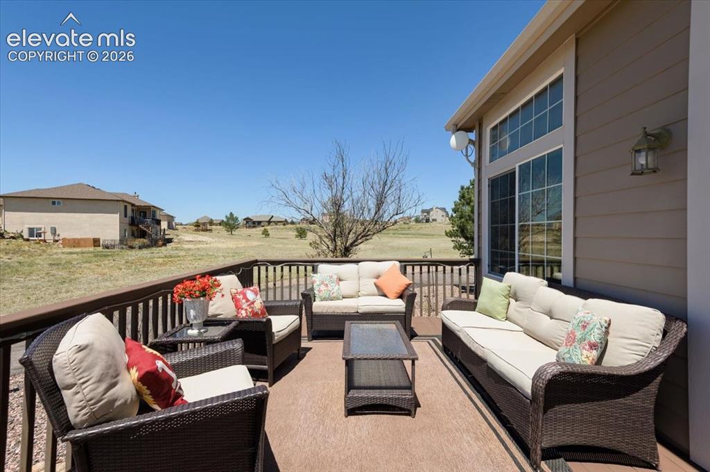 Image 19 of 47: Expansive outdoor deck featuring wood-finish flooring, a full-height patio