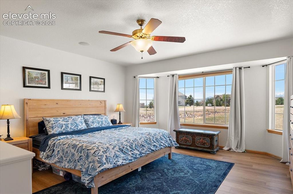 Image 21 of 47: Bedroom featuring wood-finish flooring, a ceiling fan with integrated light