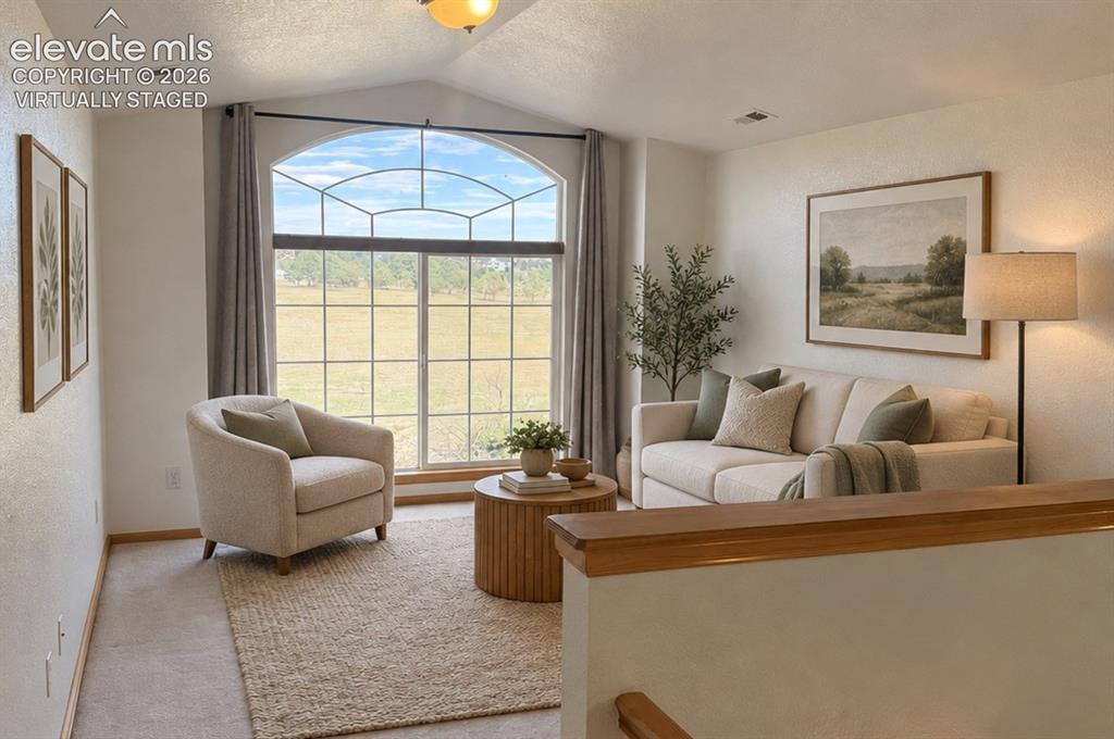 Image 23 of 48: Vaulted ceiling, large arched window with grid pattern, light-toned wall pa