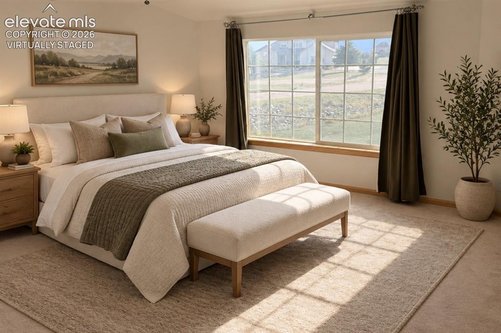 Image 25 of 48: Upstairs bedroom 1/3 w/ large walk-in closet. Expansive window with mountai
