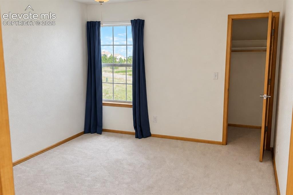 Image 28 of 48: Upstairs bedroom 2/3. Neutral-toned walls complement the light-colored carp