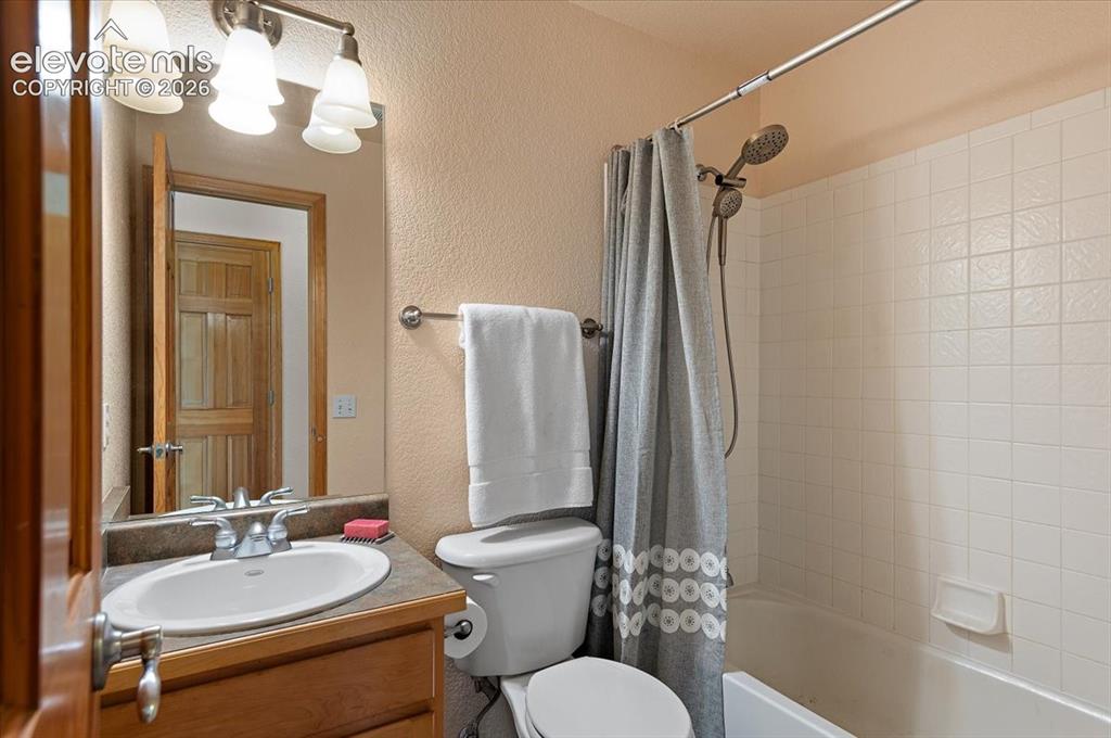 Image 29 of 47: Bathroom featuring a vanity with a white oval sink, chrome faucet, and a st