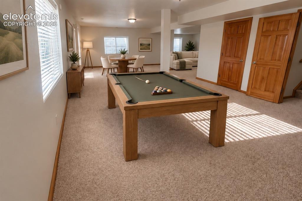 Image 33 of 48: Full expansive walk-out basement. Neutral carpeting, recessed lighting, and