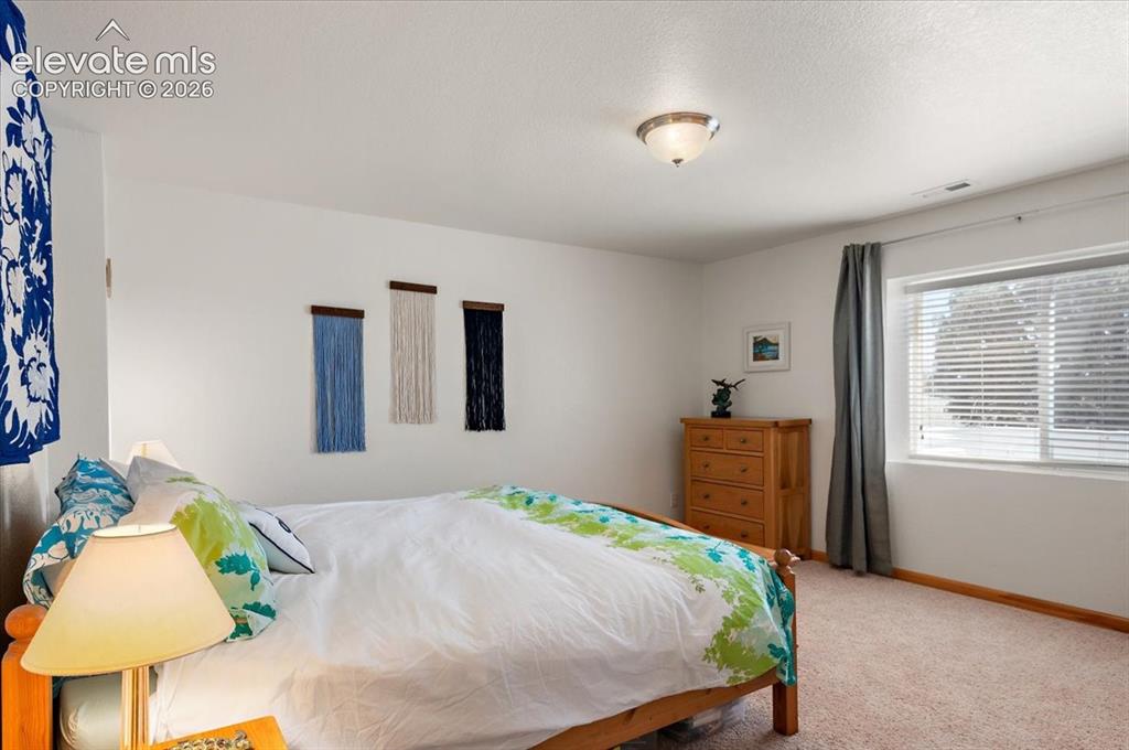 Image 37 of 47: Spacious room featuring neutral carpeting and white walls