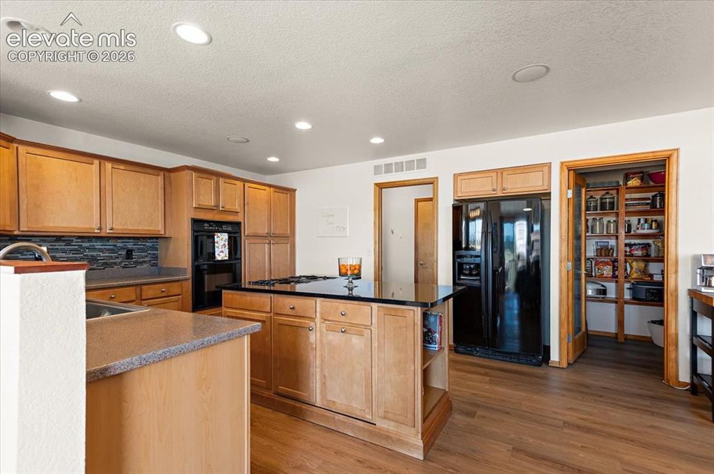 Image 9 of 47: Kitchen featuring recessed lighting, wood-finish flooring, light wood cabin