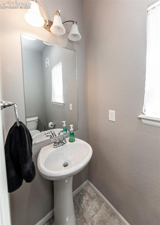 Image 17 of 40: Bathroom with baseboards and toilet