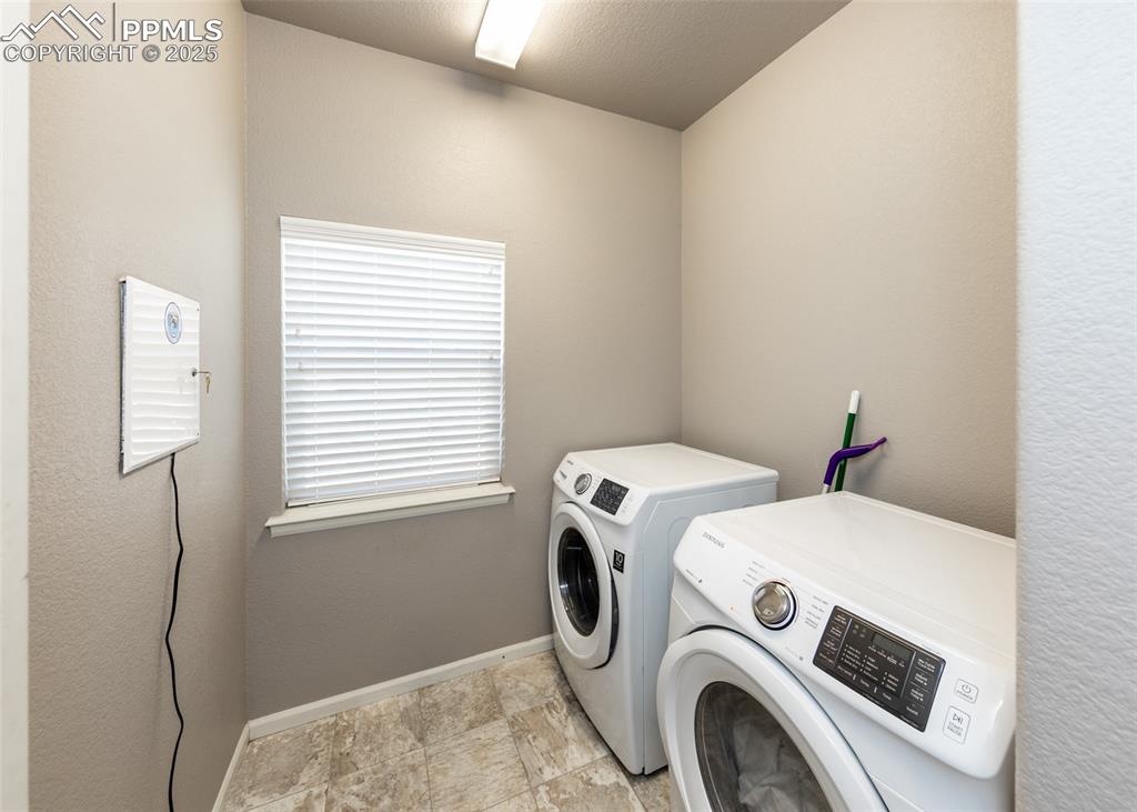 Image 19 of 40: Laundry area featuring independent washer and dryer and baseboards