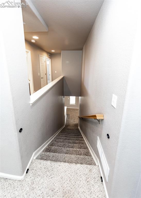 Image 20 of 40: Staircase with carpet flooring and recessed lighting