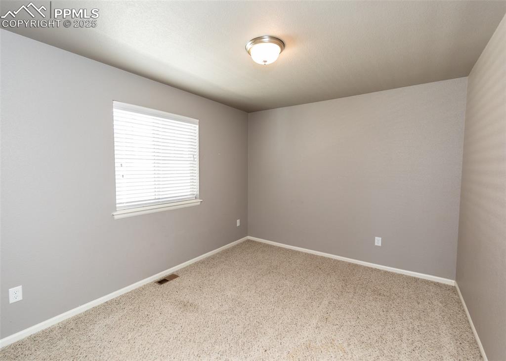 Image 35 of 40: Spare room featuring carpet flooring